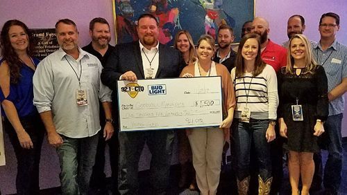 Sean McCutcheon's Air Conditioning giving back to the community - money to Goodwill Sean McCutcheon's team presenting donation to Goodwill Manasota at Young Guns of Country show.